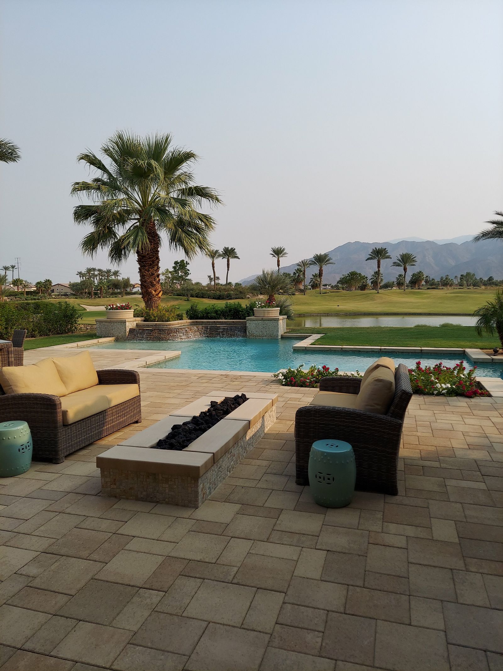 A large paver patio with seating area