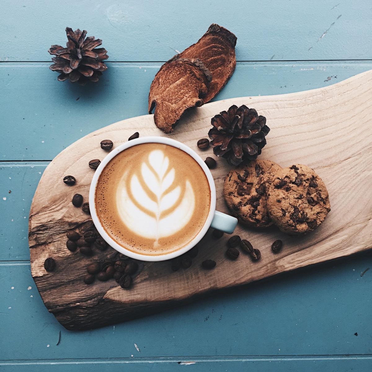 Latte with rosetta art on a live-edge board