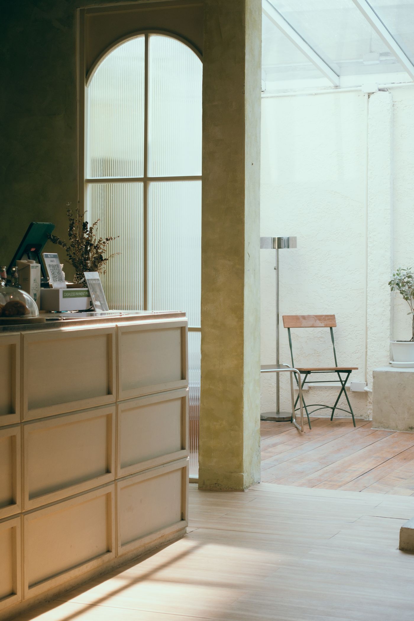 A sunlit calm studio counter with arched window