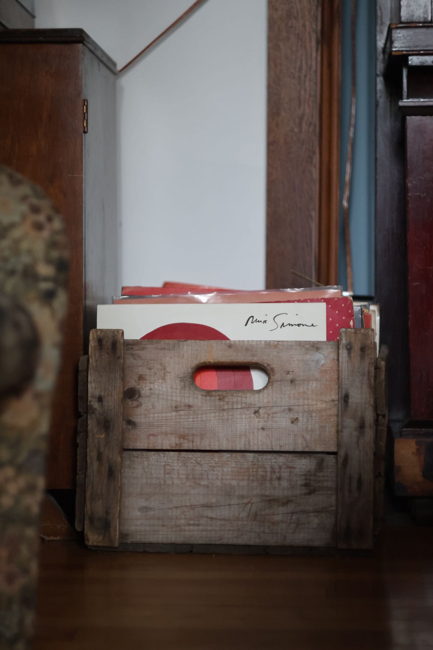 A wooden crate of records