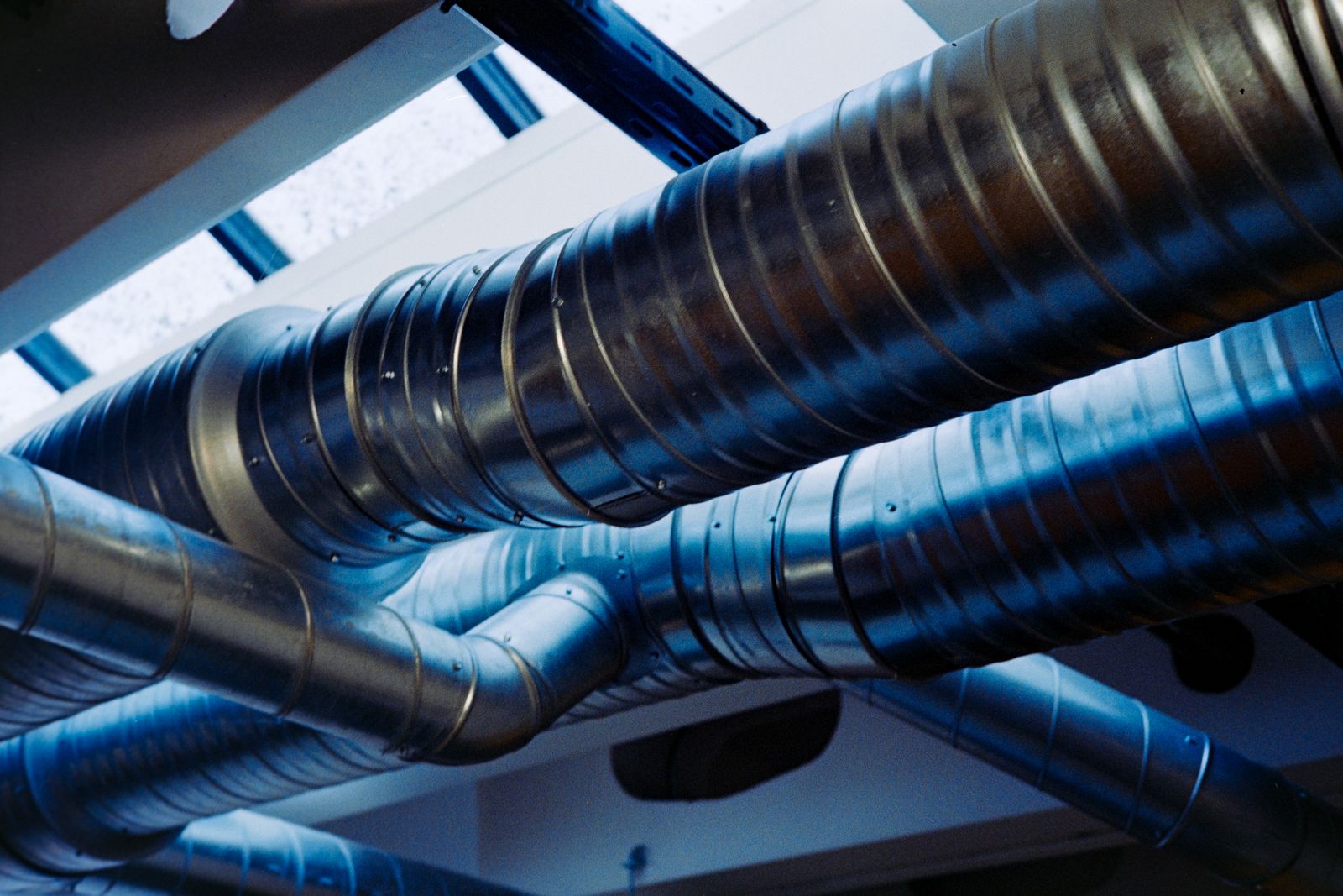Spiral metal ductwork across a ceiling