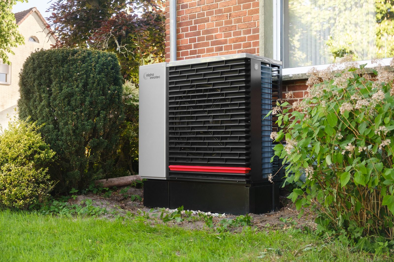 An outdoor air-source heat pump beside a home