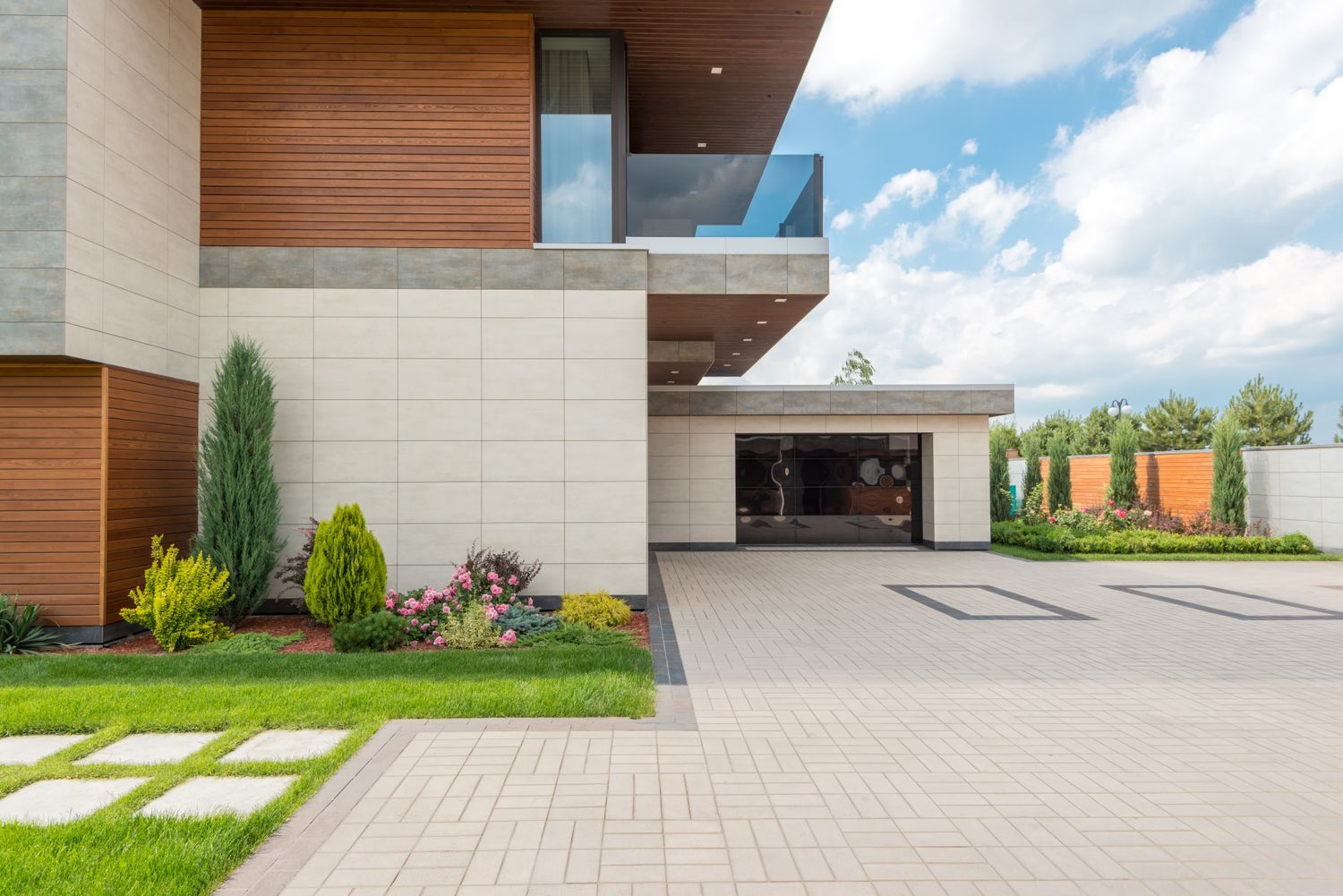 A freshly paved interlocking-stone driveway leading to a home