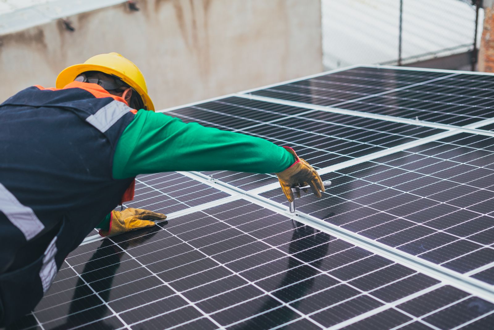 Hands setting a solar panel into place
