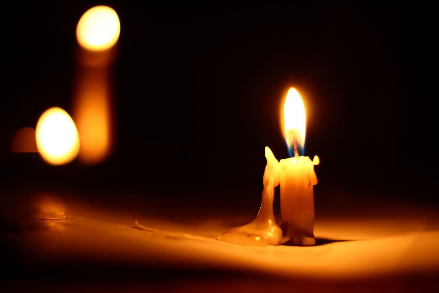 A lit candle with warm glow