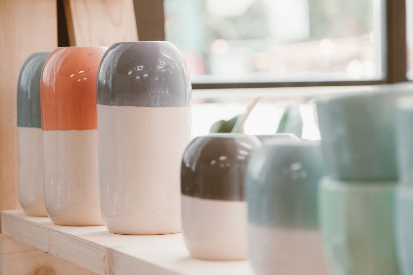 Two-tone ceramic vases on a shelf