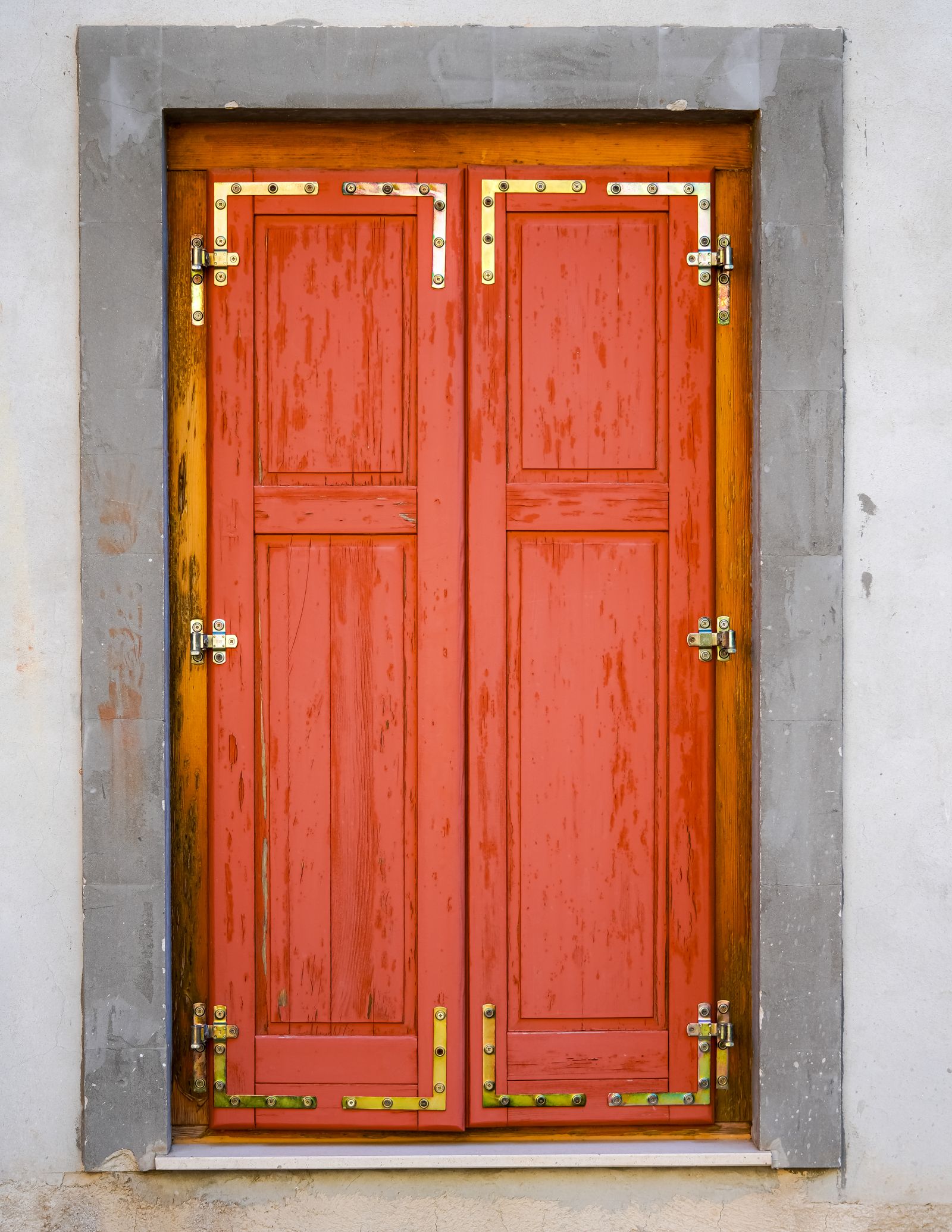 A red door with brass hinges