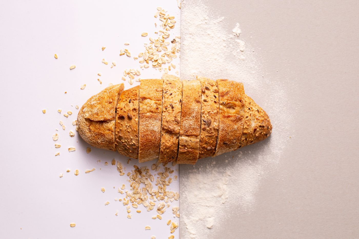 A sliced seeded loaf with oats