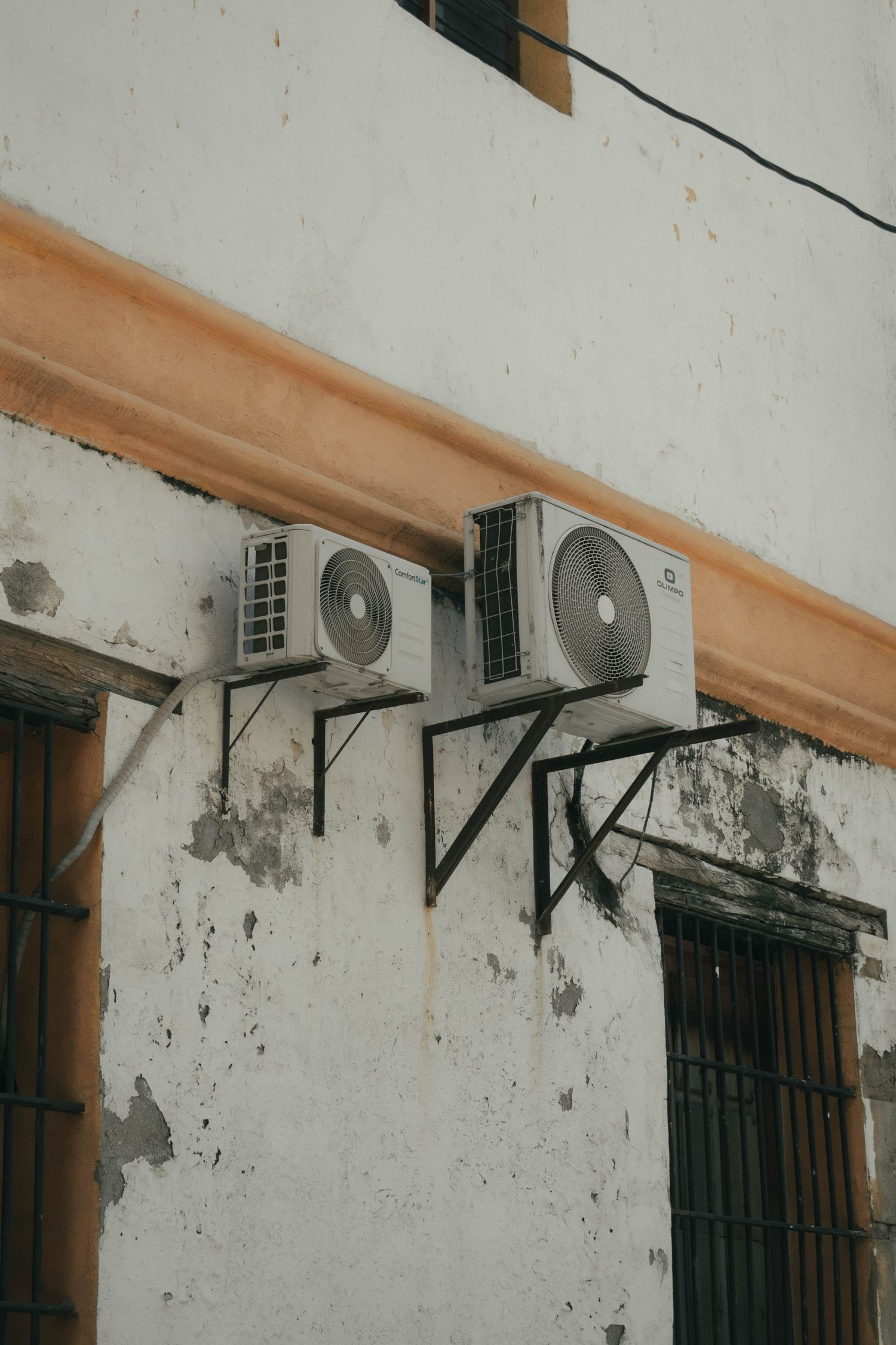 Refrigeration gauges, valves and a pump mounted on a wall