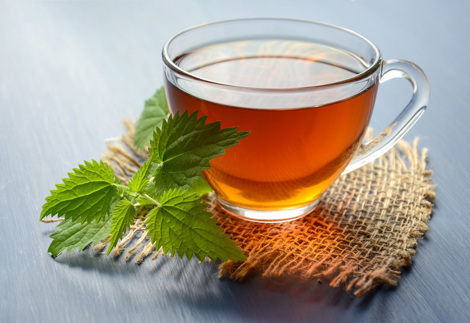 A glass cup of tea with fresh mint