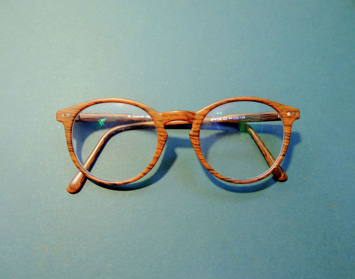 Wood-grain frames on a teal background