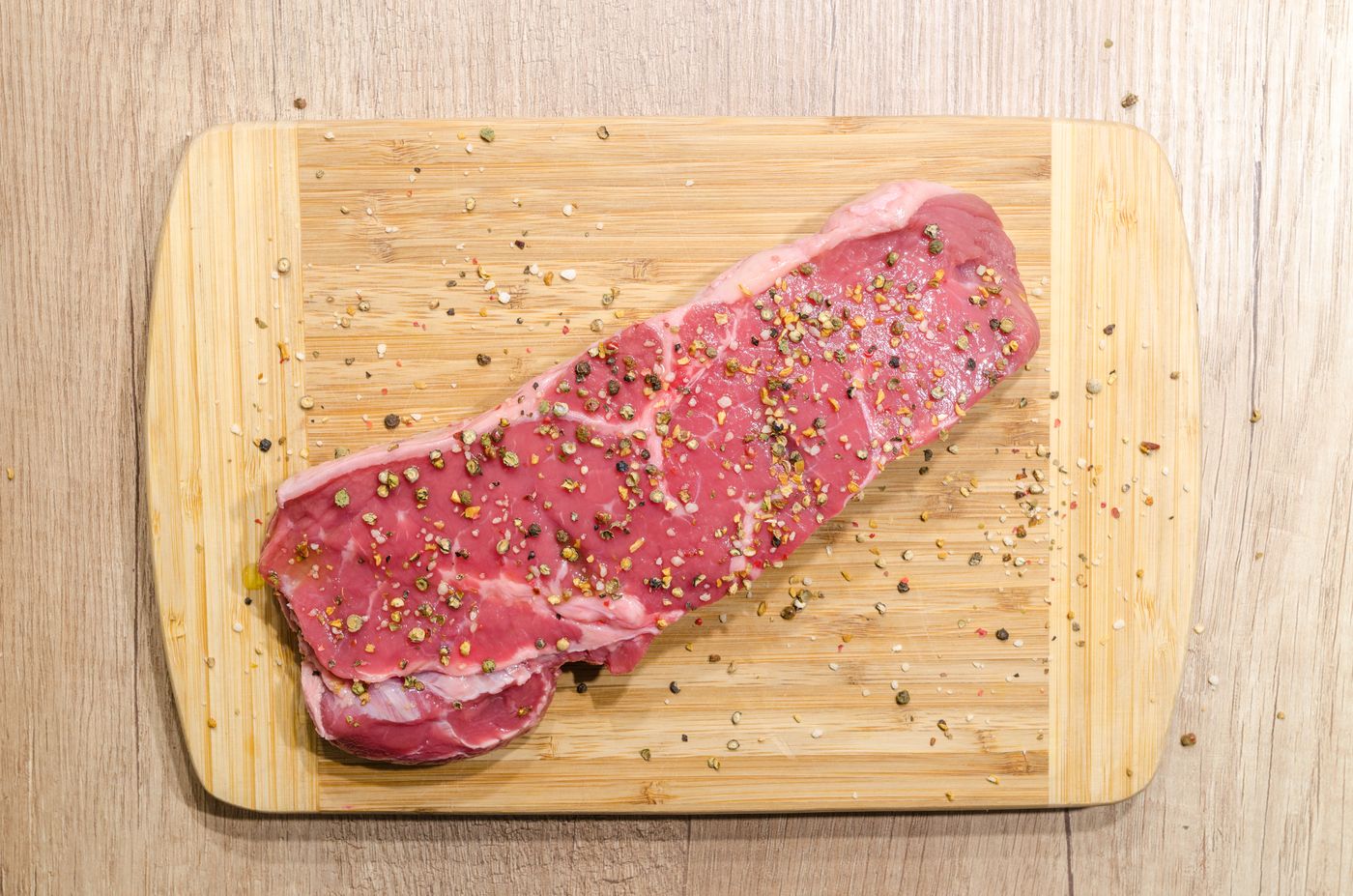 Raw cuts of meat on a wooden butcher's block