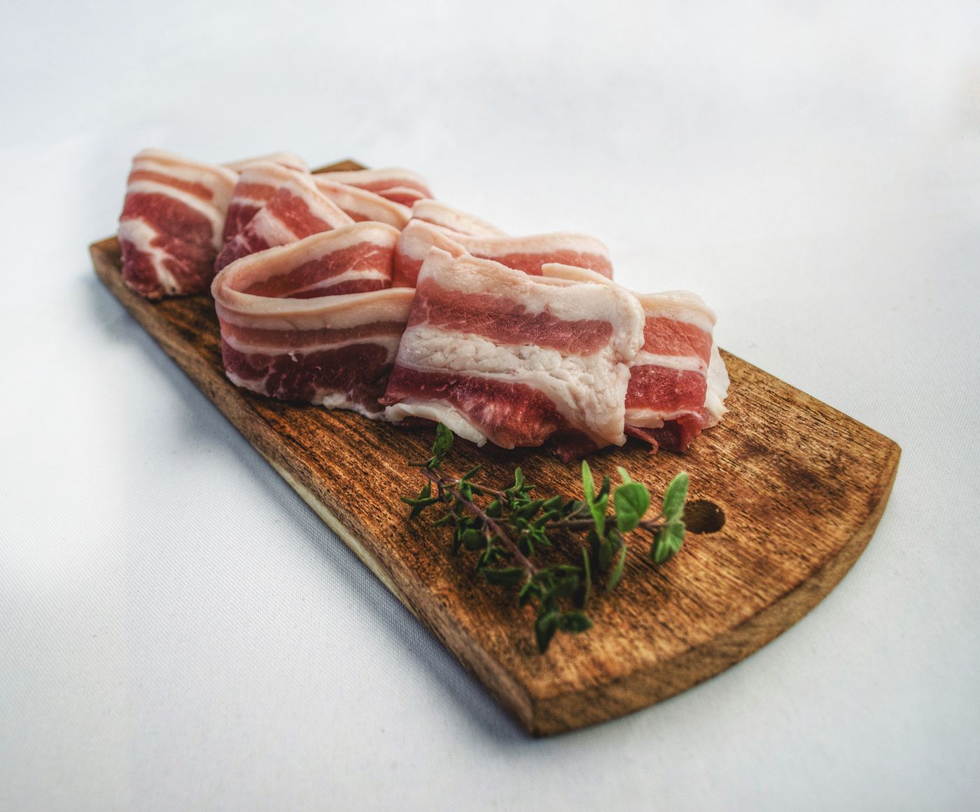 Fresh-cut bacon on a wooden board