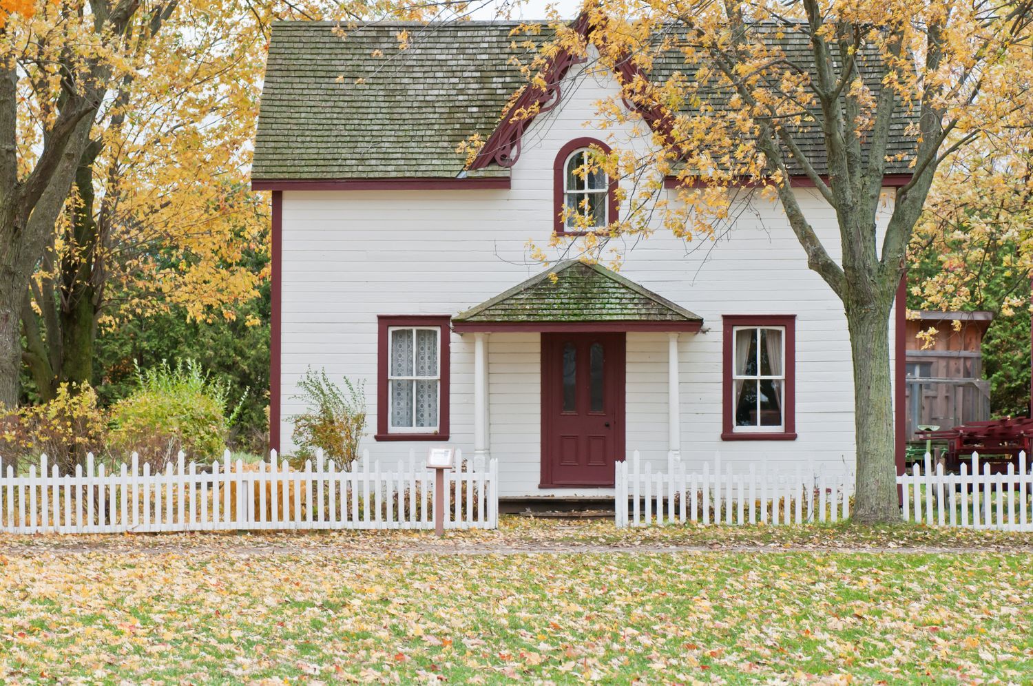 Cottage home in fall with gutters