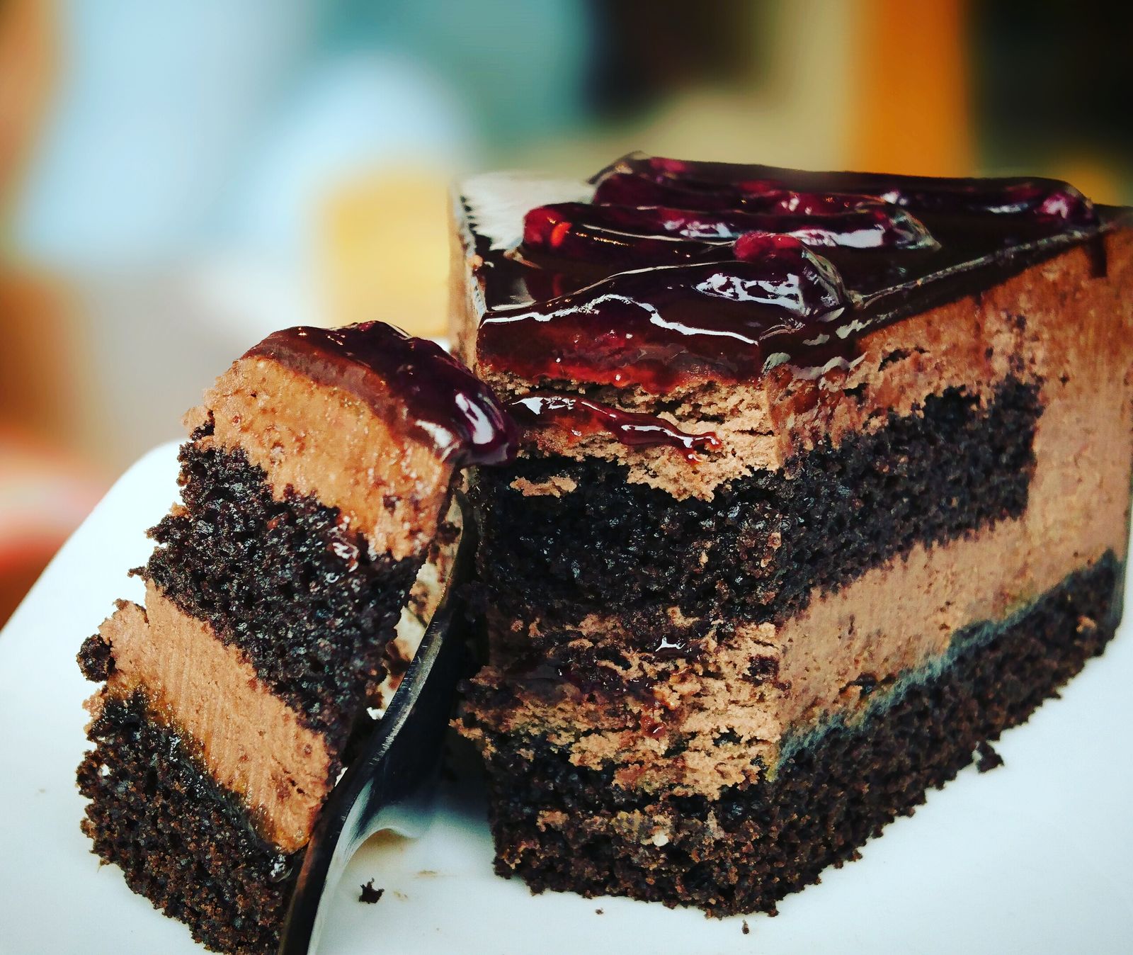 Cross-section of a layered cake with berries and cream