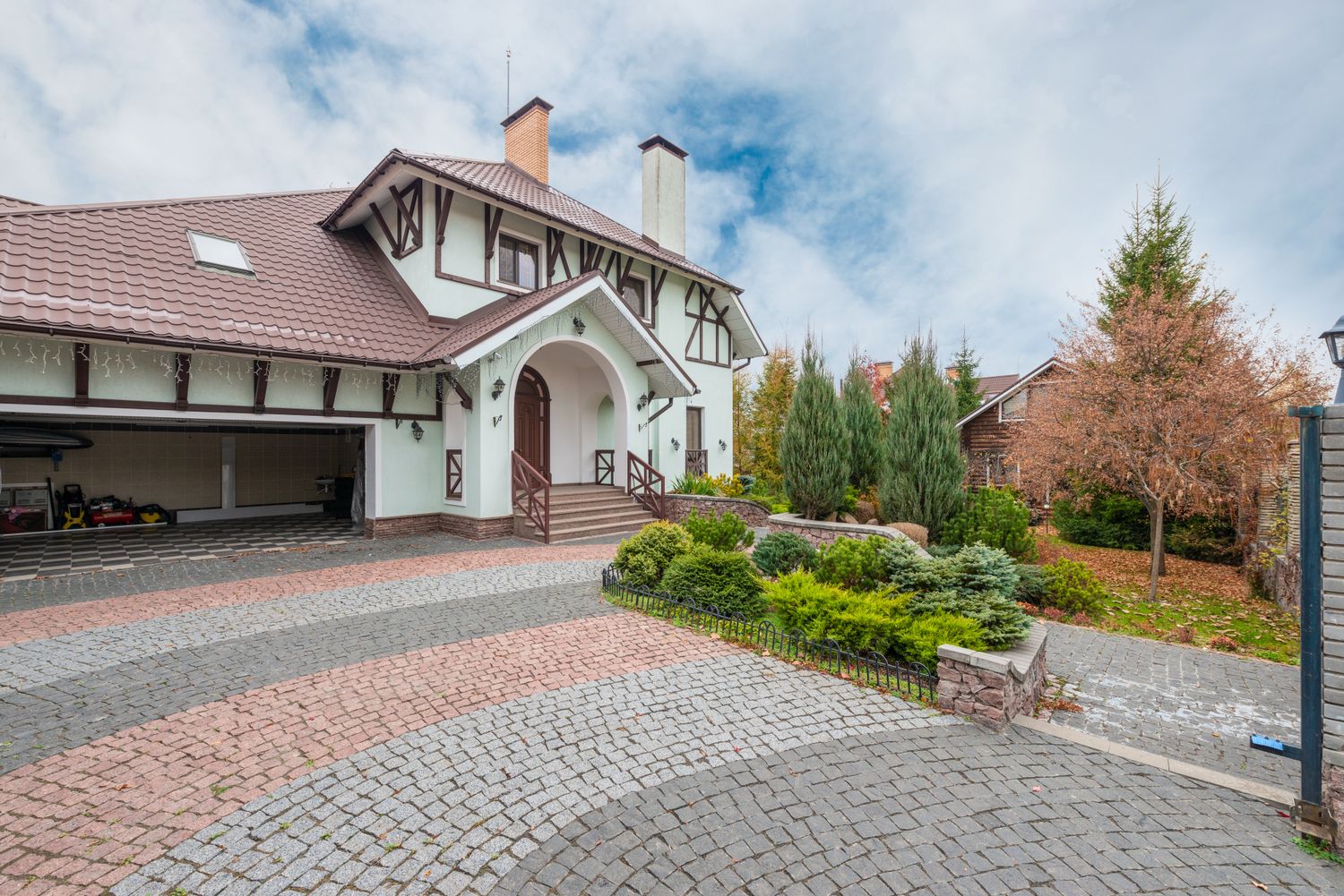 Home with finished brick driveway