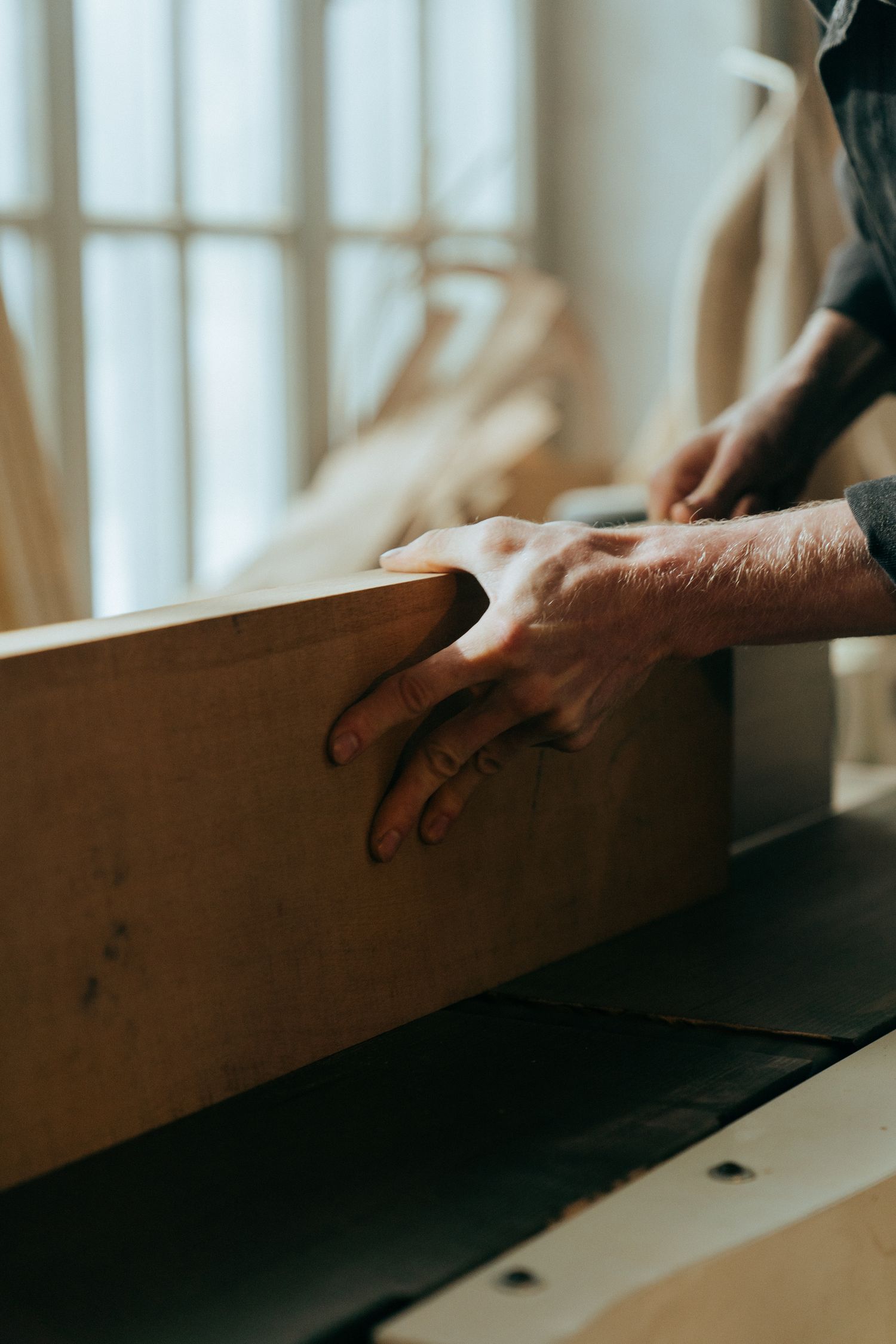 Hands holding a freshly finished sample board