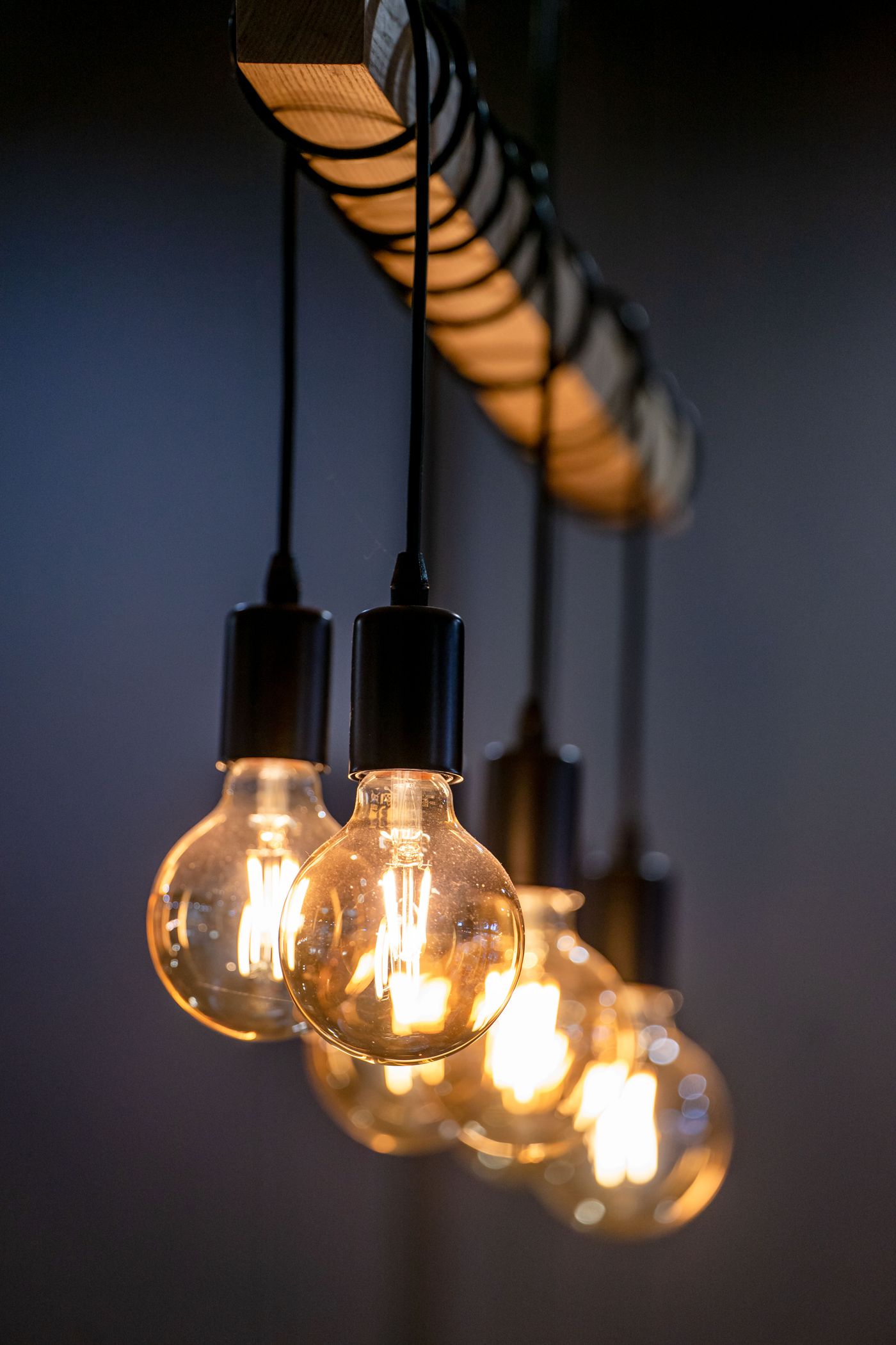 A row of warm filament pendant bulbs