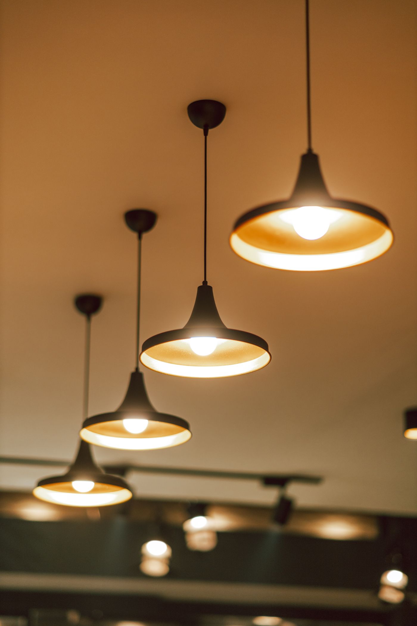 Warm pendant lights fitted to a ceiling