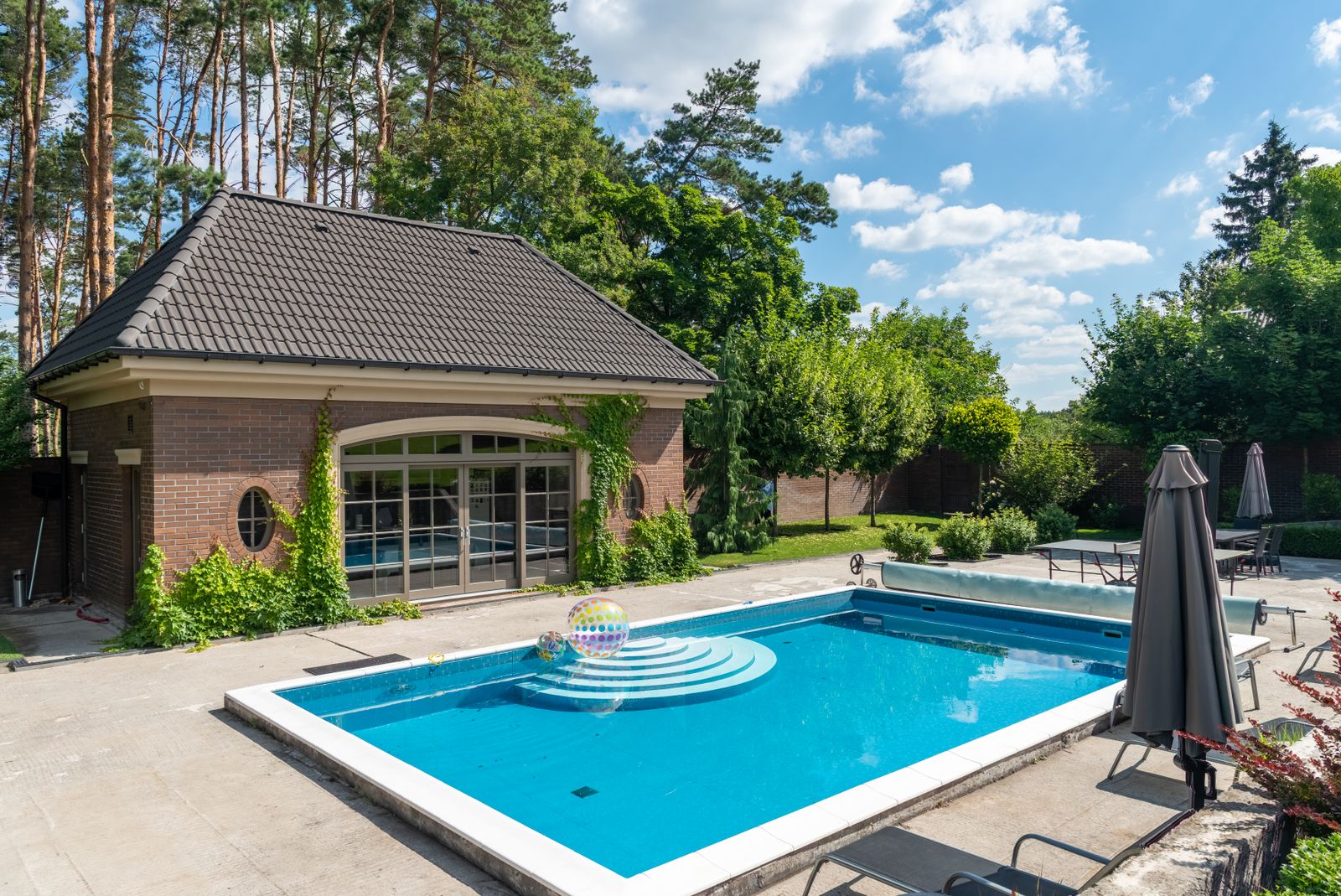 Backyard pool with brick poolhouse