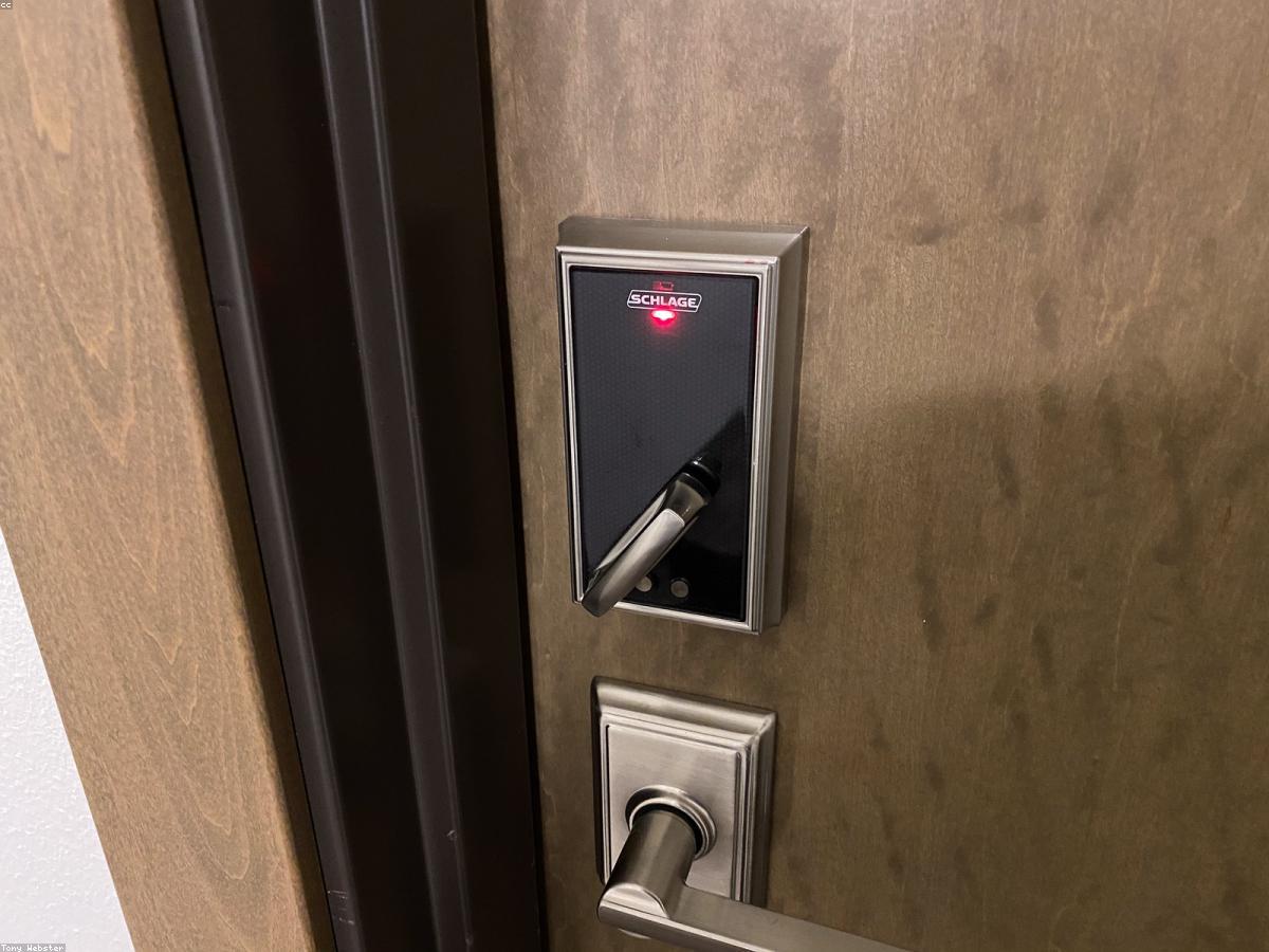 A keyed deadbolt and smart lock installed on a door